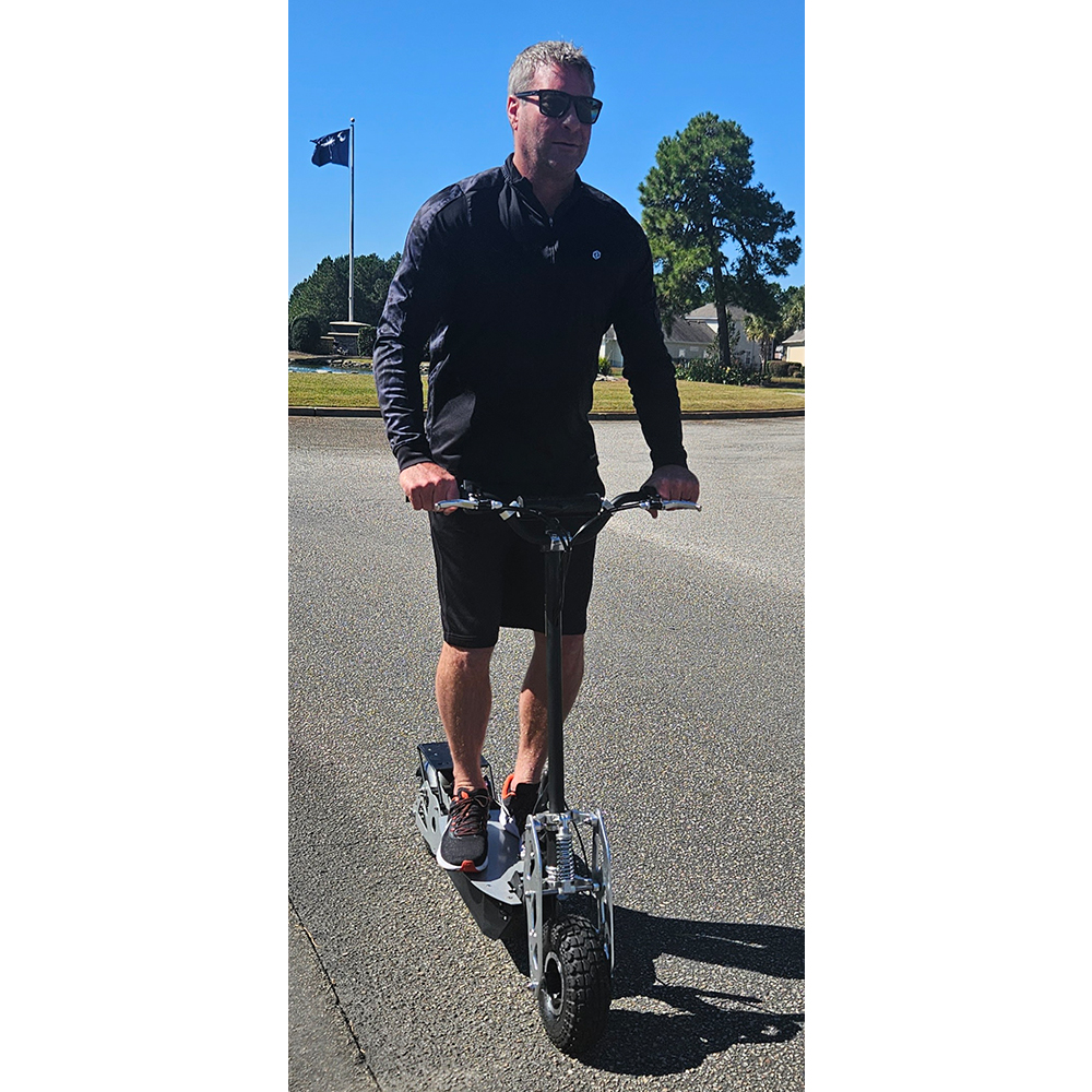 A man riding the 1200 watt lithium scooter